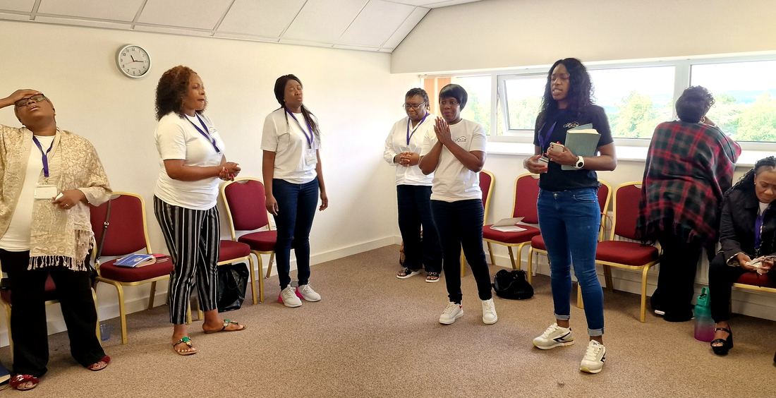 Women in prayer at a KWOW retreat